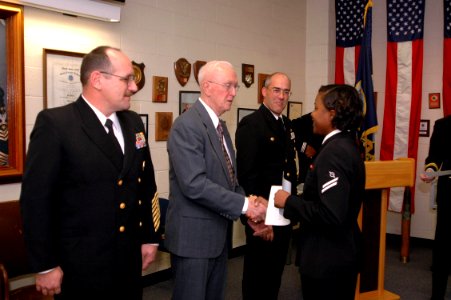 US Navy 070126-N-2456S-073 The Third Master Chief Petty Officer of the Navy (MCPON) Robert J. Walker congratulates Operations Specialist Seaman Apprentice D'Ebony Simons on graduating from