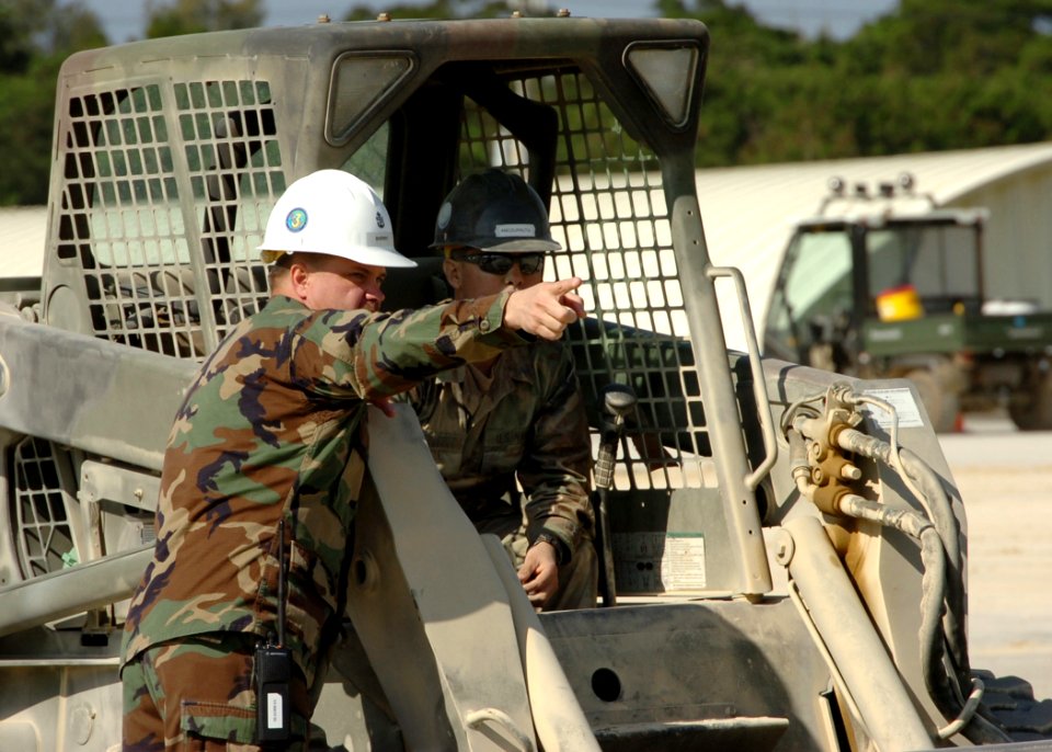 US Navy 070125-N-0775Y-063 Chief Utilitiesman James Sherry instructs Equipment Operator Constructionman Albert Amozarrutia in the direction to continue cleaning during a runway repair exercise at Kadena Air Base, Okinawa