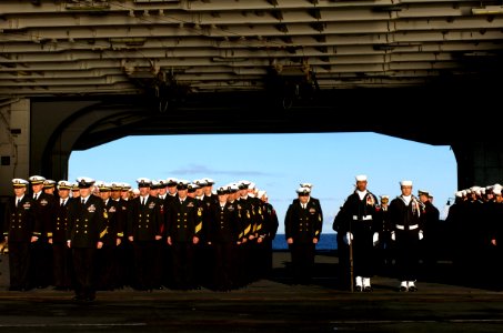 US Navy 070130-N-0555B-039 Sailors assigned to the Eagles of Strike Fighter Squadron One One Five (VFA-115) honor one of their own during a burial at sea ceremony held aboard USS Ronald Reagan (CVN 76) photo