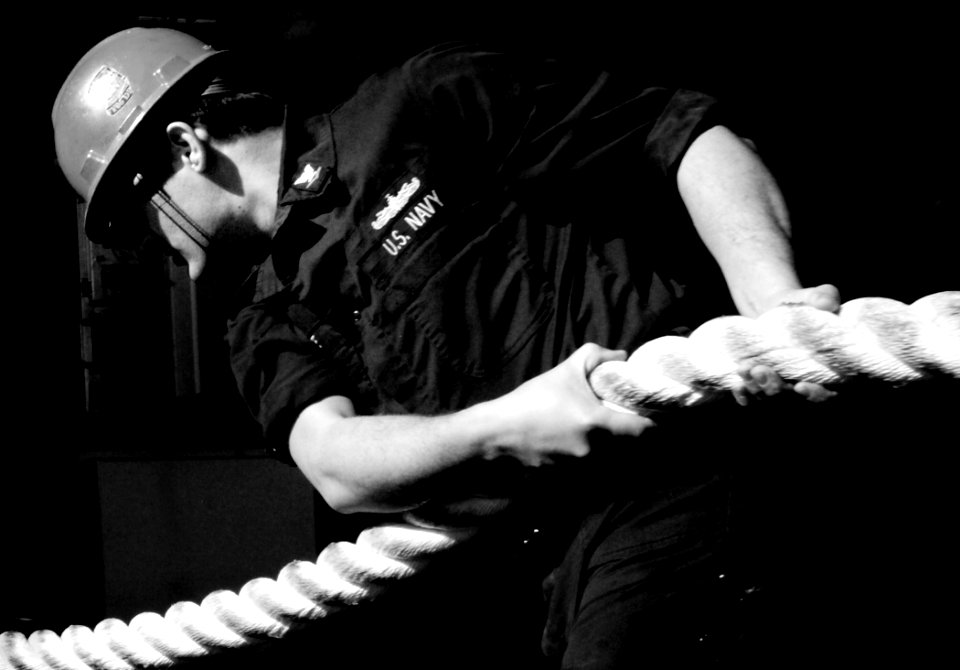 US Navy 070126-N-8923M-027 A Sailor assigned to deck department takes in a mooring line on the fantail as the Nimitz-class aircraft carrier USS Harry S. Truman (CVN 75) gets underway
