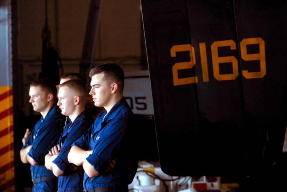 US Navy 070130-N-2659P-122 Sailors pause from work to watch the ocean outside the hangar bay doors aboard Nimitz-class aircraft carrier USS John C. Stennis (CVN 74)