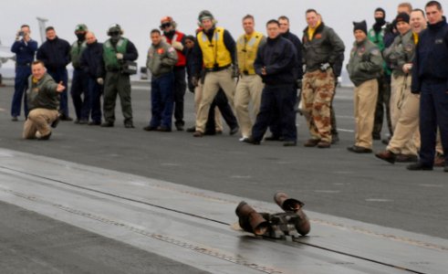 US Navy 070121-N-5345W-061 Lt. Cmdr. Robert Stark holds his shoot stance while his boots speed down catapult number one during a boot shoot ceremony on the flight deck of the Nimitz-class aircraft carrier USS Harry S. Truman (C