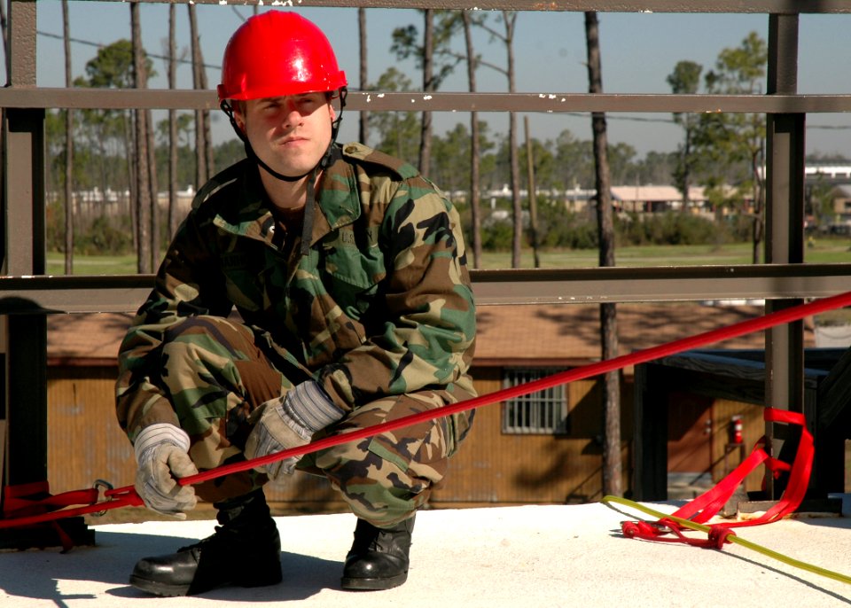US Navy 070126-N-3857R-005 Yeoman 3rd Class Samuel VanHouten, assigned to Naval Mobile Construction Battalion One (NMCB-1) secures a line which will be used as an anchor for lowering a litter containing a wounded survivor off o