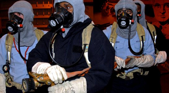 US Navy 070126-N-8923M-135 A fire party assigned to repair locker one bravo responds to a simulated fire in the hangar bay during a general quarters drill aboard Nimitz-class aircraft carrier USS Harry S. Truman (CVN 75)