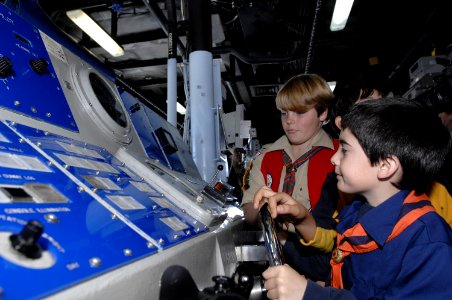 US Navy 070127-N-4954I-067 A cub scout from Cub Scout Pack 774 turn the ship's helm on the bridge aboard USS Peleliu (LHA 5)
