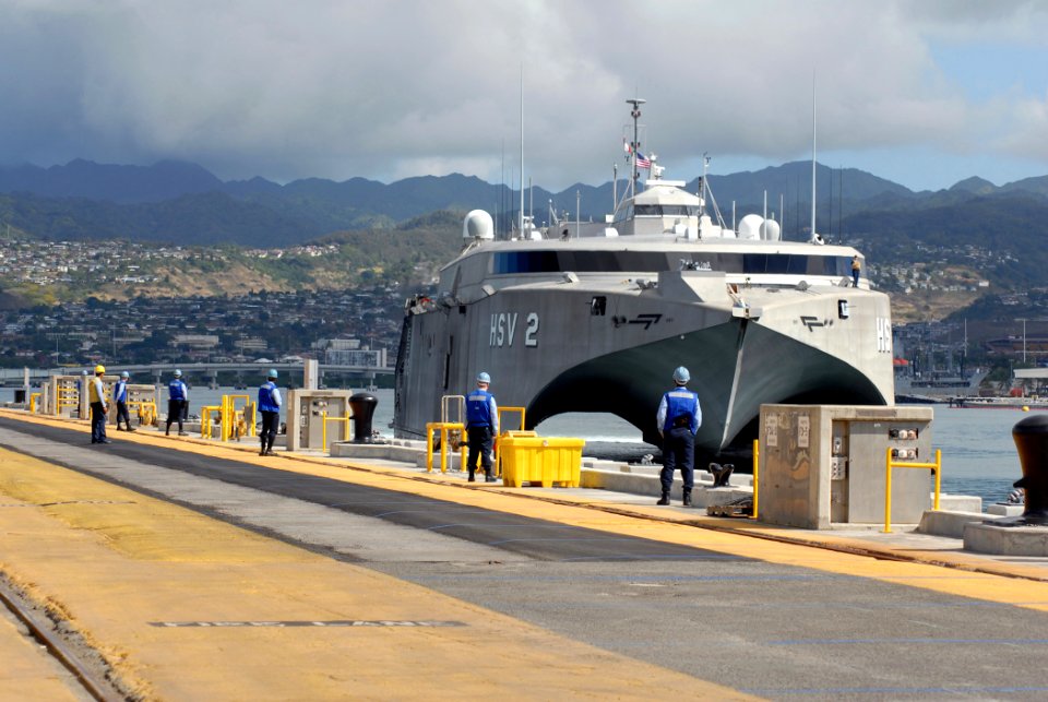 US Navy 070125-N-4965F-008 Sailors assigned to Ticonderoga-class guided missile cruiser USS Port Royal (CG 73) line the pier waiting to perform line handling duties for U.S. Navy High-Speed Vessel (HSV-2) Swift as she prepares