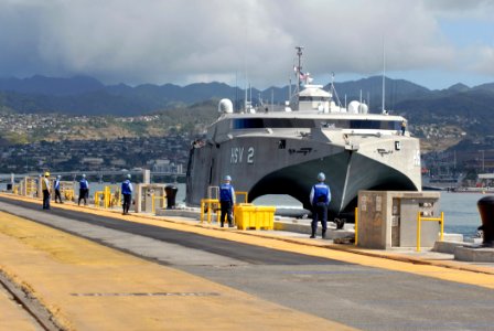 US Navy 070125-N-4965F-008 Sailors assigned to Ticonderoga-class guided missile cruiser USS Port Royal (CG 73) line the pier waiting to perform line handling duties for U.S. Navy High-Speed Vessel (HSV-2) Swift as she prepares