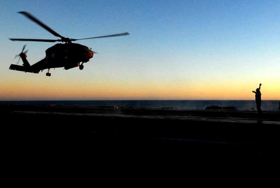 US Navy 070128-N-3729H-129 An SH-60F Seahawk assigned to the Eightballers of Helicopter Anti-Submarine Squadron Eight (HS-8) is directed to the landing area by a landing signalman enlisted