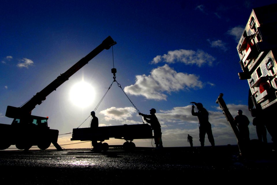 US Navy 070125-N-0684R-044 Fire controlmen assigned to combat systems department lift a case of RAM-116 Rolling Airframe Missiles (RAM) to load into the RAM Battery by crane aboard the Nimitz-class aircraft carrier USS John C