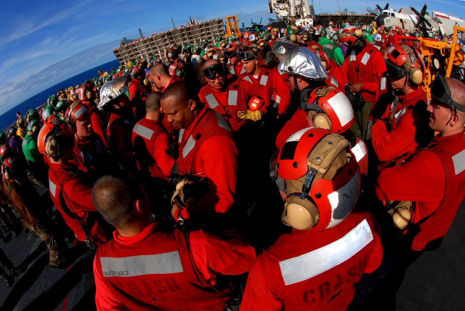 US Navy 070203-N-0684R-040 Sailors assigned to air department's crash and salvage team debrief their exercises after completing flight deck drills