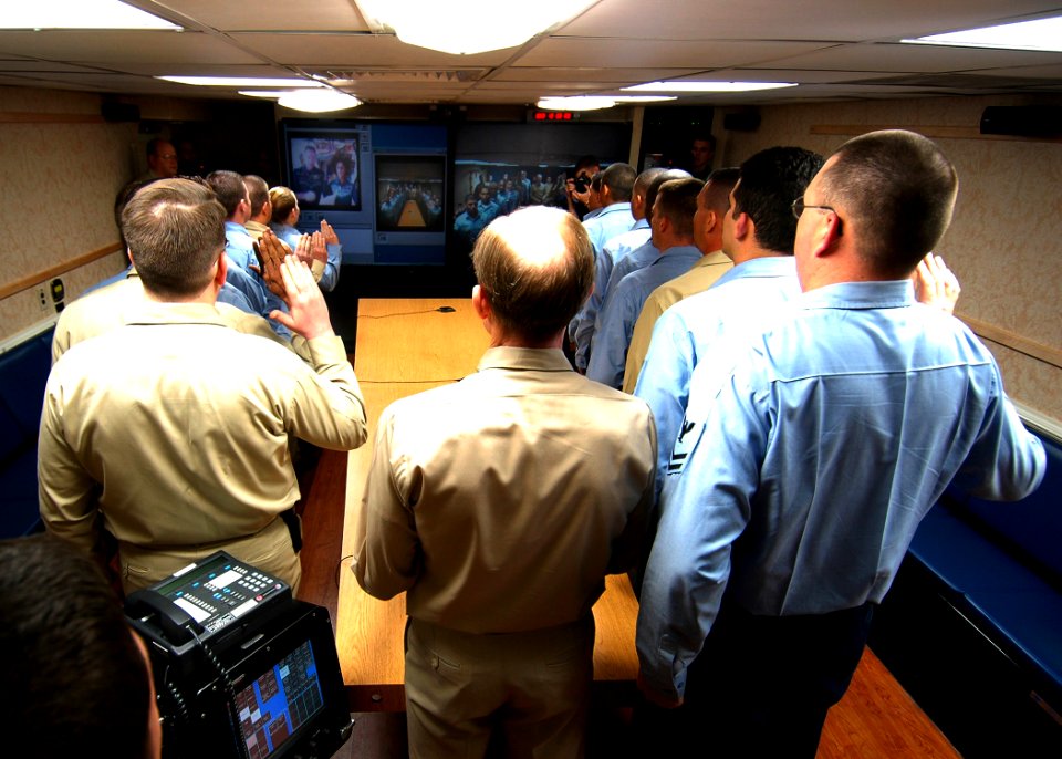 US Navy 070129-N-0490C-001 Orbiting 200 miles above Earth, astronauts, U.S. Navy Capt. Michael Lopez-Alegria and flight engineer U.S. Navy Cmdr. Suni Williams reenlist 16 Sailors aboard Nimitz-class aircraft carrier USS Dwight