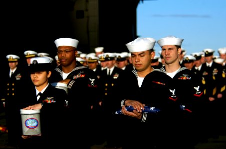 US Navy 070130-N-0555B-075 Sailors assigned to the Eagles of Strike Fighter Squadron One One Five (VFA-115) honor one of their own during a burial at sea ceremony held aboard USS Ronald Reagan (CVN 76) photo