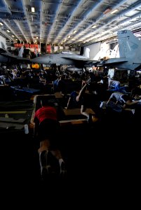 US Navy 070130-N-0684R-016 Sailors take time to do some physical training in the hangar bay aboard Nimitz-class aircraft carrier USS John C. Stennis (CVN 74)