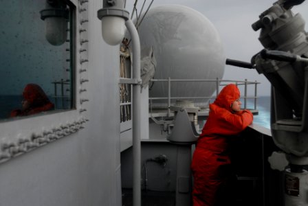 US Navy 070130-N-2959L-185 Standing the lookout watch through a rainstorm, Seaman Sarah Hernandez from Fontana, Calif., continues a vigilant watch on board USS Ronald Reagan (CVN 76)