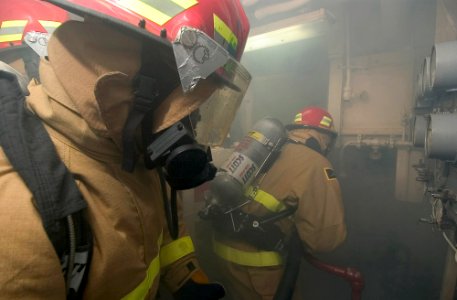 US Navy 070126-N-8534H-013 Sailors enter an auxiliary space to contain a simulated Class Bravo Fire during a general quarters drill aboard the guided missile frigate USS Gary (FFG 51)