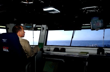 US Navy 070204-N-4009P-101 Capt. Terry B. Kraft, commanding officer of Nimitz-class aircraft carrier USS Ronald Reagan (CVN 76), watches Super Bowl XLI on the bridge