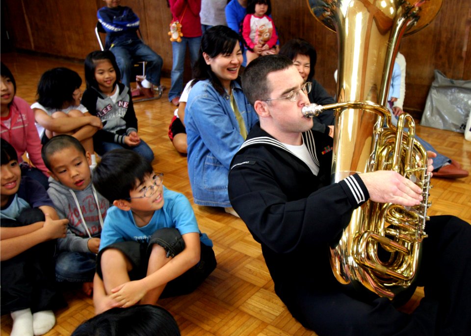 US Navy 070127-N-1113S-005 Musician 3rd Class Christian Ivy plays the tuba on the floor at the Kadena Children's Center on Okinawa