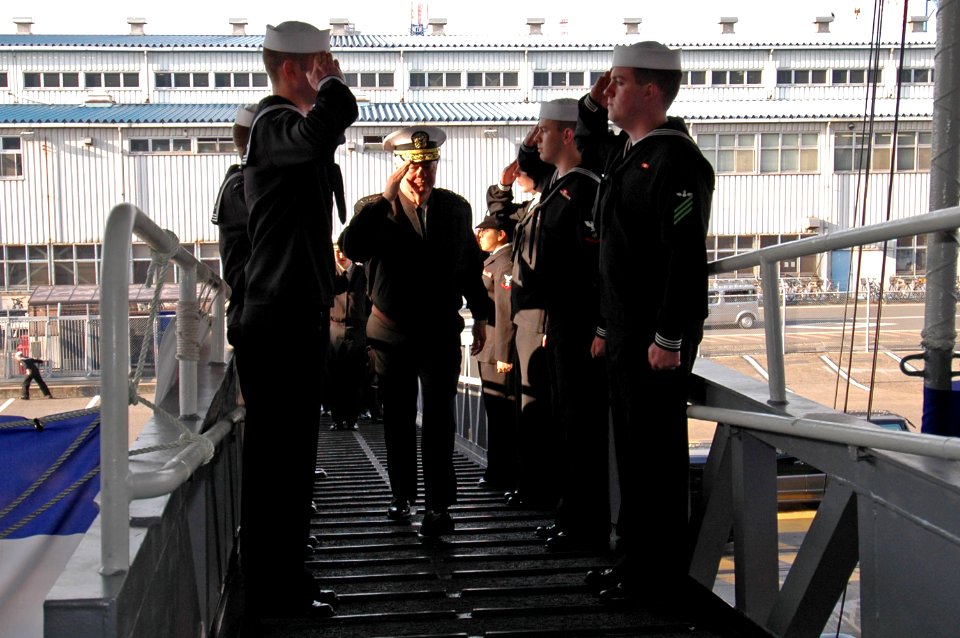 US Navy 070201-N-7883G-012 Adm. Timothy Keating, commander of North American Aerospace Defense (NORAD) and U.S. Northern Command, salutes while passing through side boys aboard USS Kitty Hawk (CV 63)