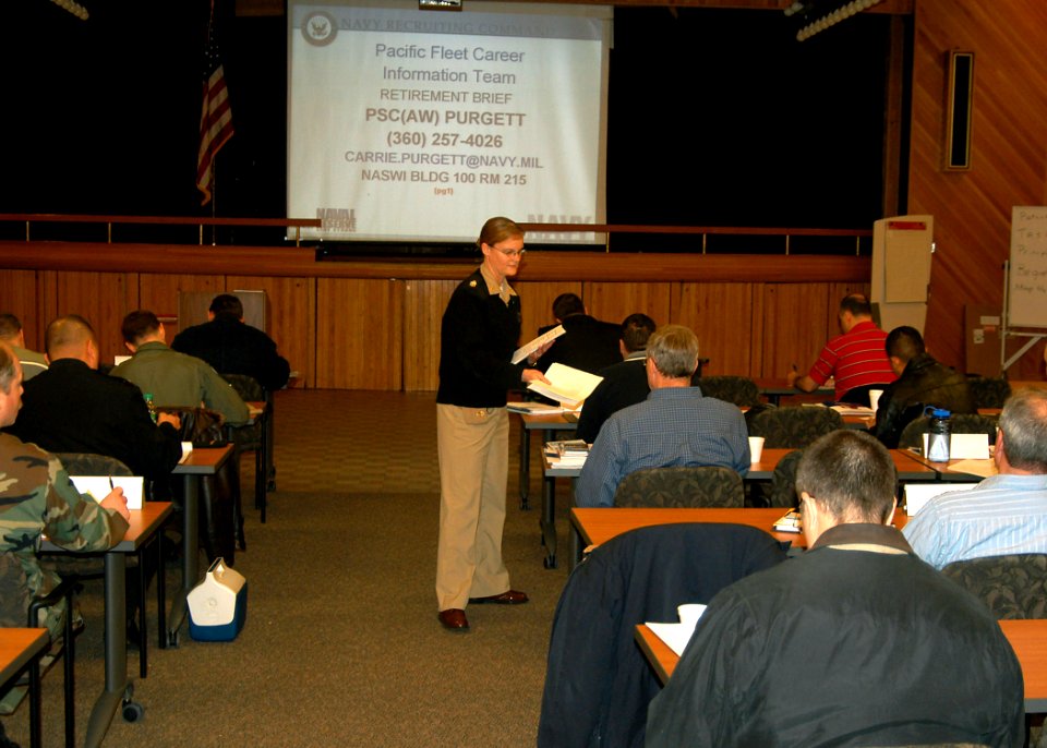 US Navy 070131-N-6247M-020 Chief Personnel Specialist Carrie Purgett, from San Jose, Calif., hands out retirement separation checklists to military members attending a Transition Assistance Program