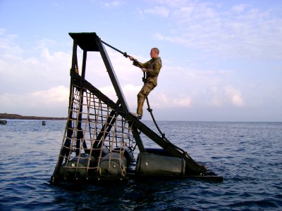 US Navy 070128-A-0000X-008 Information Systems Technician 2nd Class Brian Bell negotiates a water obstacle during the French Foreign Legion Commando course at Arta Beach in Djibouti