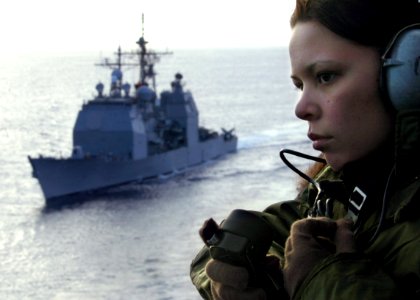 US Navy 070128-N-4009P-029 Operations Specialist 3rd Class Marian Cox from Holland, Mich., stands watch on vultures row as guided missile cruiser USS Lake Champlain (CG 57) sails alongside USS Ronald Reagan (CVN 76)