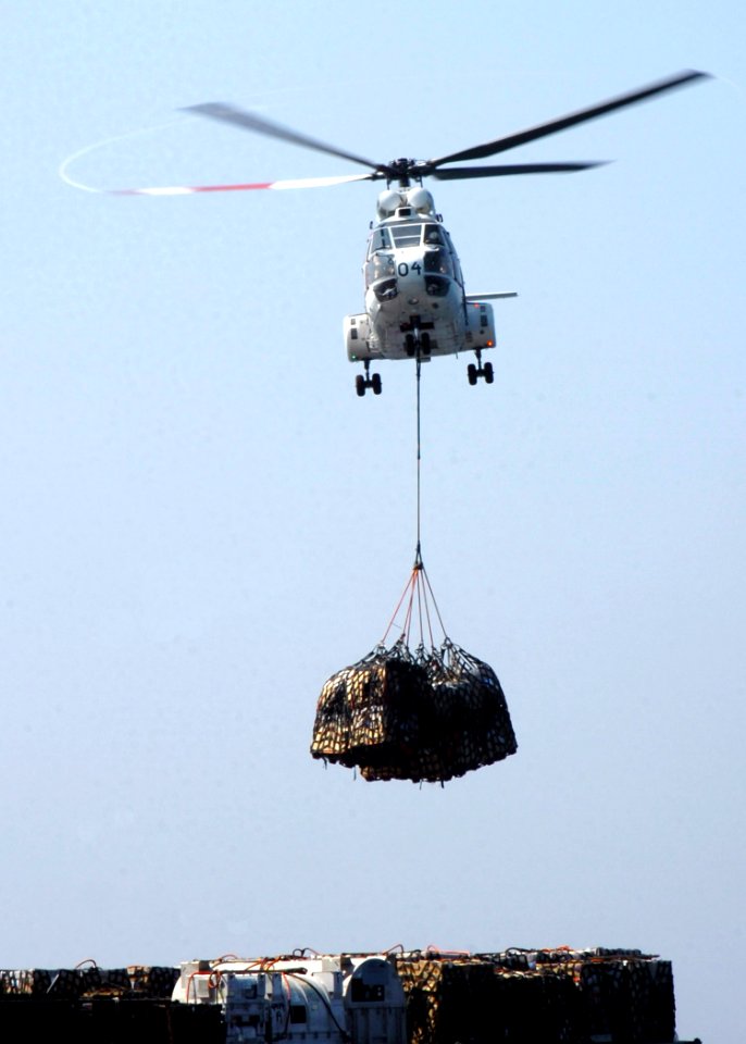 US Navy 070202-N-8907D-003 An SA-330 Puma helicopter assigned to Military Sealift Command (MSC) combat stores ship USNS Spica (T-AFS 9) lifts cargo bound for the Nimitz-class aircraft carrier USS Dwight D. Eisenhower (CVN 69) d