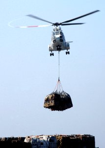 US Navy 070202-N-8907D-003 An SA-330 Puma helicopter assigned to Military Sealift Command (MSC) combat stores ship USNS Spica (T-AFS 9) lifts cargo bound for the Nimitz-class aircraft carrier USS Dwight D. Eisenhower (CVN 69) d