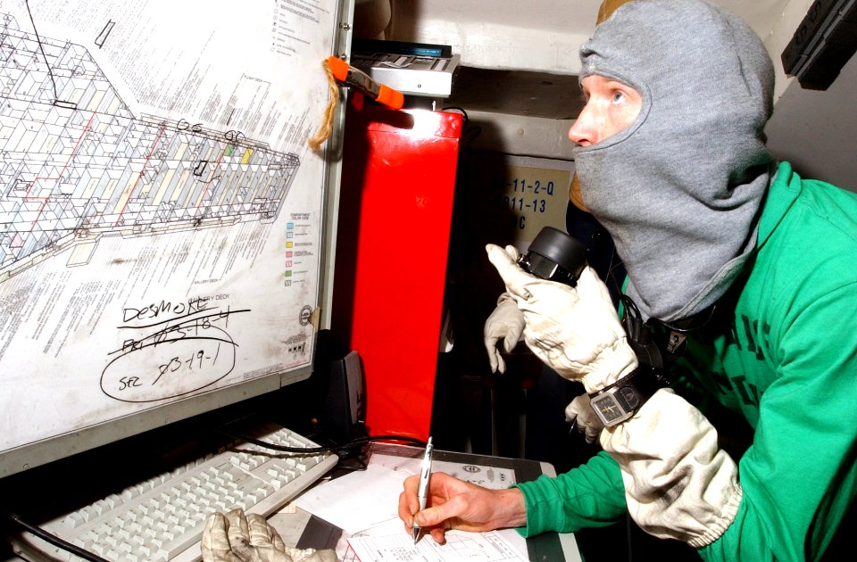 US Navy 070203-N-4009P-176 Mass Communication Specialist 2nd Class Christopher Blachly from Ridgecrest, Calif., receives a message in a repair locker during a general quarters (GQ) drill aboard Nimitz-class aircraft carrier USS