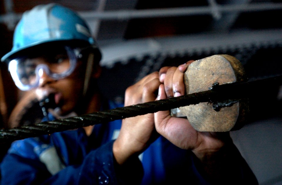 US Navy 070206-N-7130B-255 A Sailor assigned to deck department aboard USS Ronald Reagan (CVN 76) ensures the proper tracking of rope being retracted back into Underway Replenishment (UNREP) Station Fifteen following a fueling