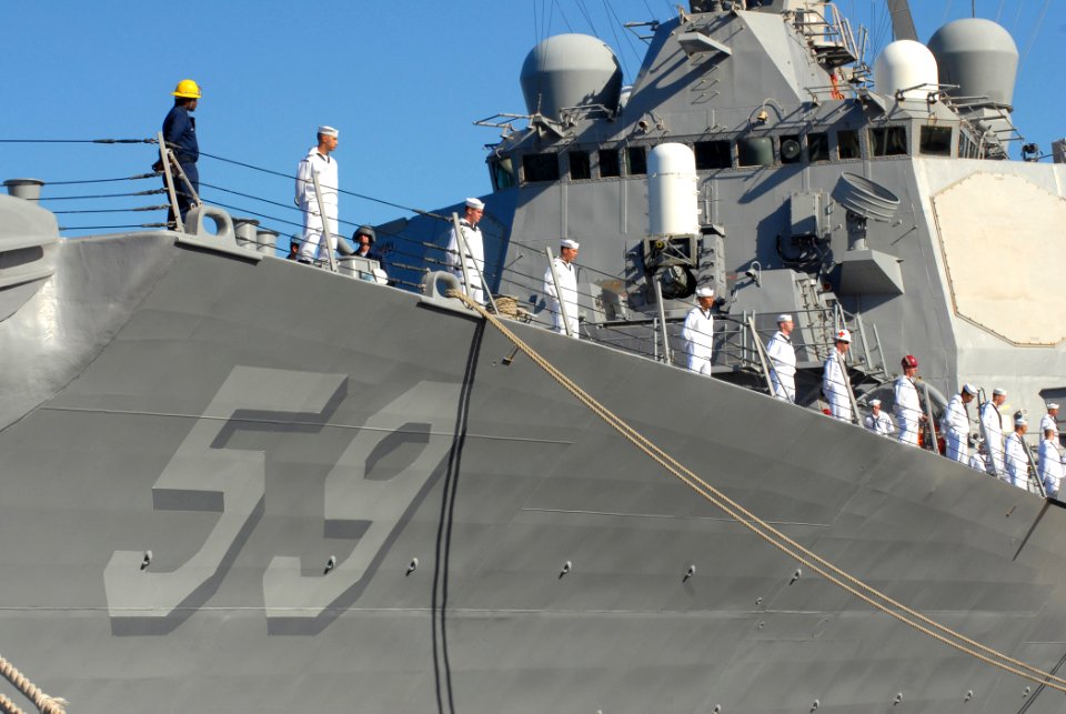 US Navy 070203-N-4965F-014 Sailors aboard guided missile destroyer USS Russell (DDG 59) man the rails prior to getting underway