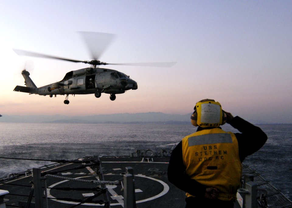 US Navy 070130-N-4649C-076 Boatswain's Mate 2nd Class Albert Sebastian clears an SH-60 helicopter assigned to Helicopter Anti-Submarine Squadron Light Five One (HSL-51), as it takes off from Arleigh Burke-class guided missile d