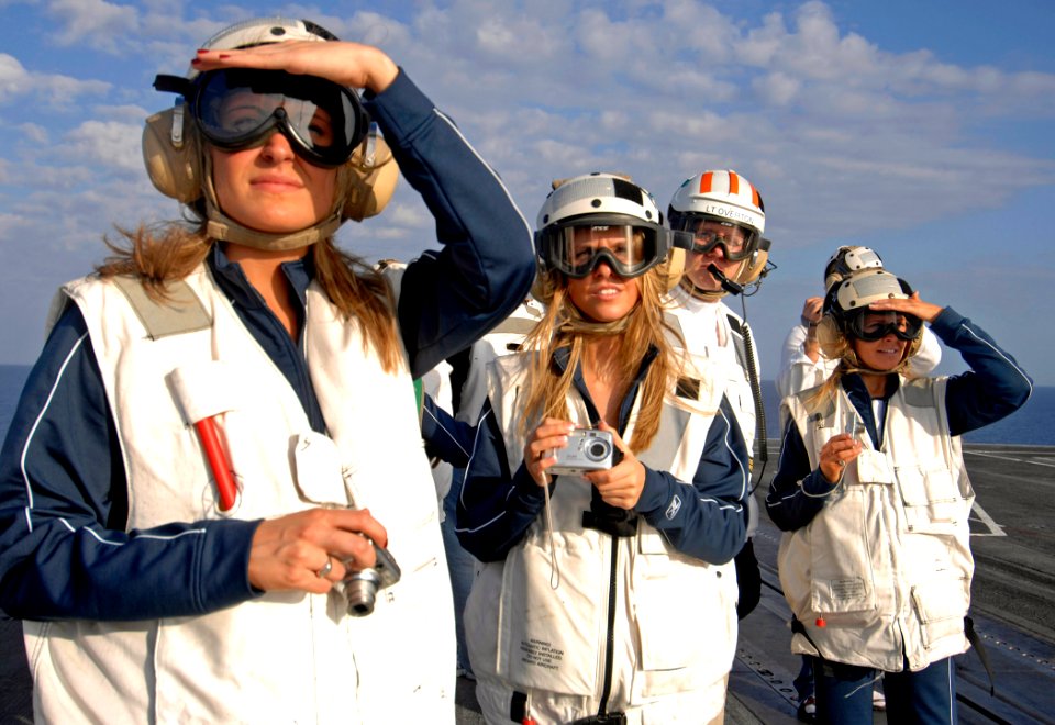 US Navy 070203-N-5345W-126 New England Patriots cheerleaders and Assistant Safety Officer Lt. Mike Overton observe flight operations from the bow aboard Nimitz-class aircraft carrier USS Harry S. Truman (CVN 75)