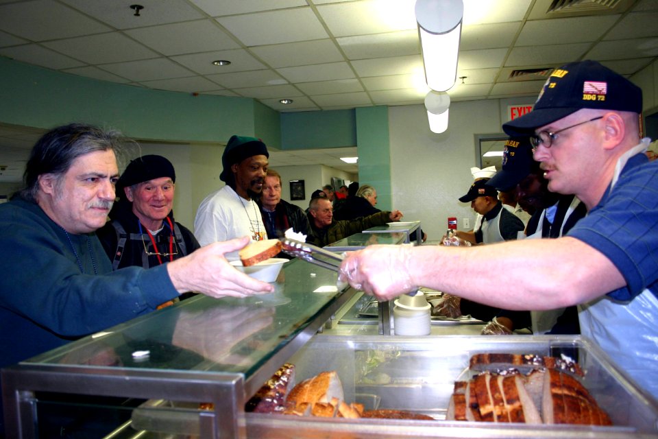 US Navy 070202-N-8110K-044 Sailors assigned to guided missile destroyer USS Mahan (DDG 72) serve lunch to homeless veterans at the New England Shelter for Homeless Veterans