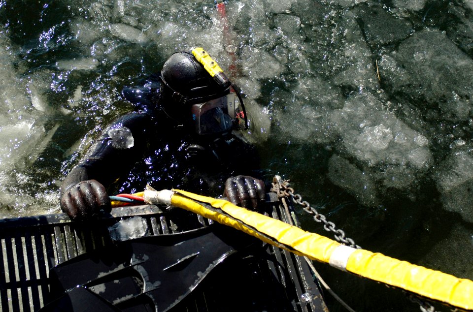 US Navy 070207-N-8467N-002 Navy Diver 3rd Class John Seagraves gets ready to start his dive off the back of the dive boat. Seagraves is part of Naval Submarine Support Facility dive locker