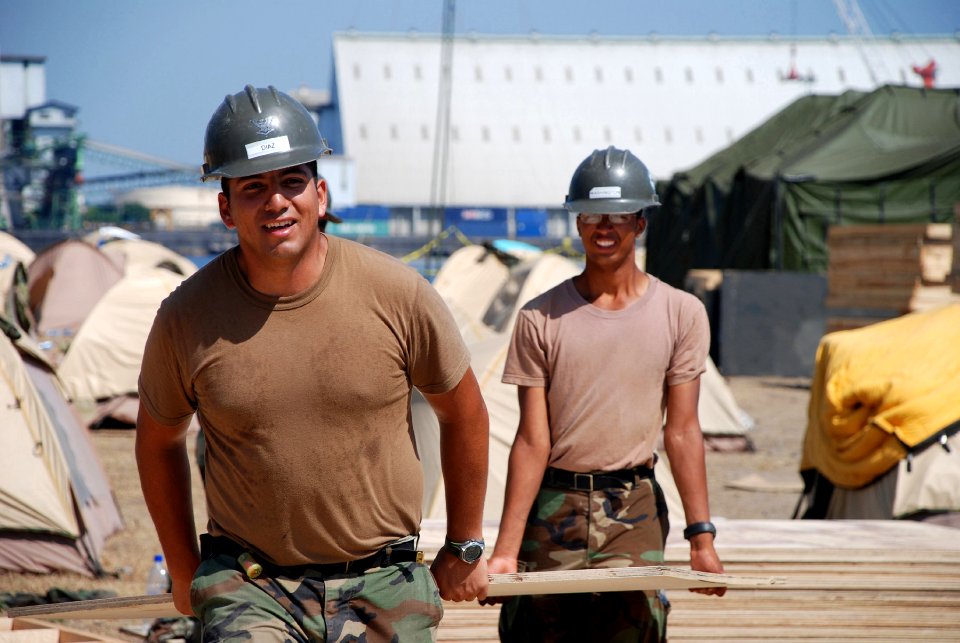 US Navy 070204-N-3589B-001 Sailors assigned to Amphibious Construction Battalion One (ACB-1) retrieve wood that will be used for the deck of a medical tent during the Humanitarian Support over the Shore (HSOTS) 2007