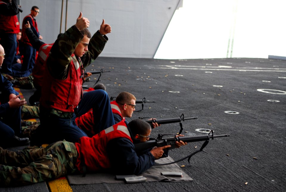 US Navy 070131-N-6326B-017 Gunners Mate 2nd Class Kyle Furlong gives the signal to shoot on the firing line of an M-16 small arms qualifying shoot aboard nuclear-powered aircraft carrier USS Nimitz (CVN 68)