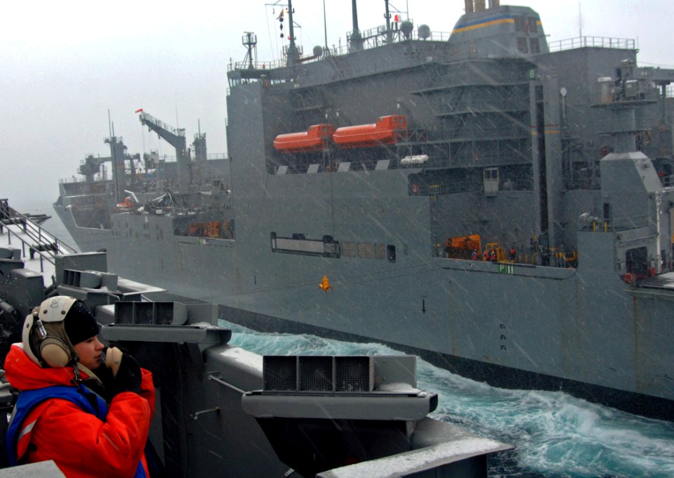 US Navy 070207-N-8923M-016 Operations Specialist 3rd Class Jeana Mullen talks on a sound-powered telephone as Nimitz-class aircraft carrier USS Harry S. Truman (CVN 75) pulls alongside Military Sealift Command (MSC) dry cargo-a