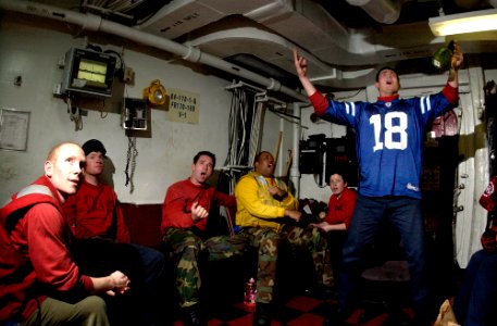 US Navy 070204-N-7130B-085 In the crash and salvage office aboard Nimitz-class aircraft carrier USS Ronald Reagan (CVN 76), Sailors erupt as the Indianapolis Colts score a touchdown during a live broadcast of Super Bowl XLI