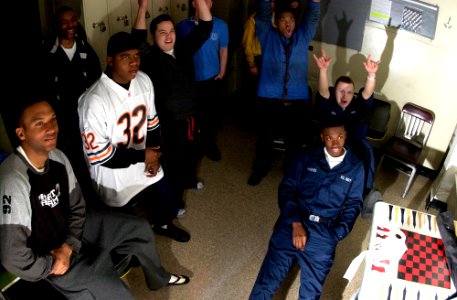 US Navy 070204-N-7130B-067 Cheers of joy and looks of disbelief paint the faces of Sailors assigned to Nimitz-class aircraft carrier USS Ronald Reagan's (CVN 76) V-1 division of air department photo