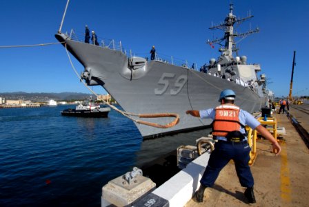 US Navy 070203-N-4965F-016 A Sailor assigned to Naval Station Pearl Harbor releases a mooring line for guided missile destroyer USS Russell (DDG 59) as the ship prepares to get underway