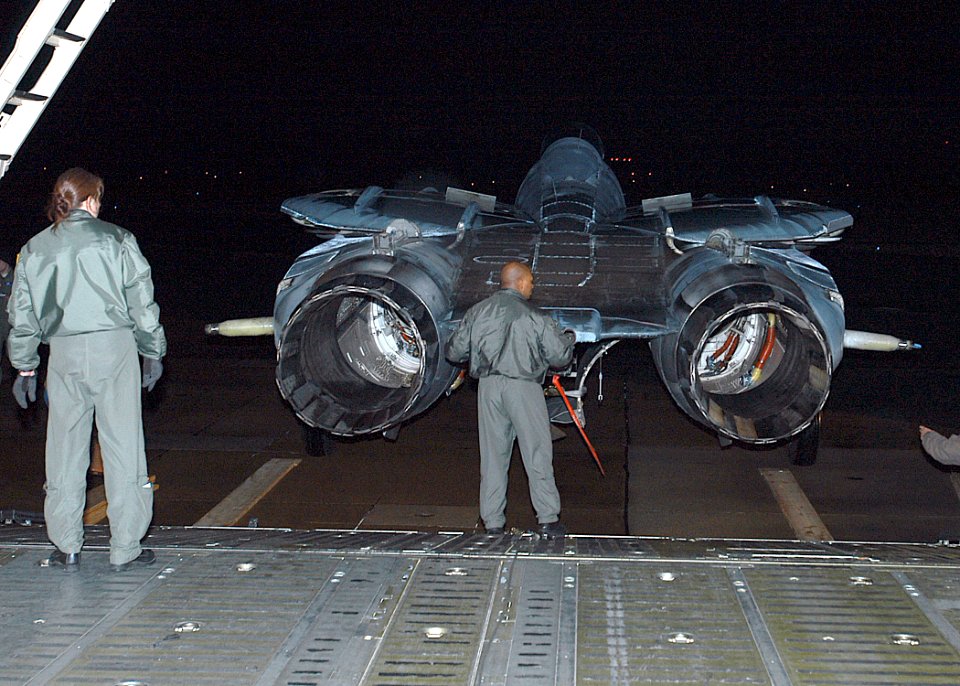 US Navy 070205-N-1082Z-045 Master Sgt. Brenda Kremer watches as Master Sgt. Bernard London performs a final inspection on the last F-14 Tomcat from Fighter Squadron Thirty One (VF-31) before it's loaded into a C-5 Galaxy