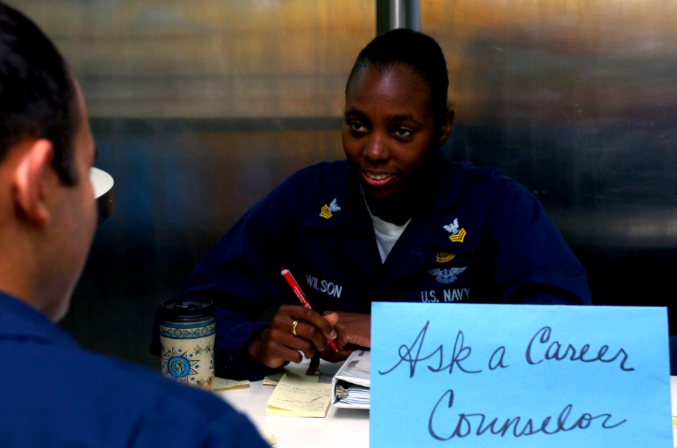 US Navy 070205-N-0555B-006 Navy Counselor 1st Class Fonda Wilson, from Hollywood, Fla., discusses career paths with a Sailor on the mess decks aboard USS Ronald Reagan (CVN 76)