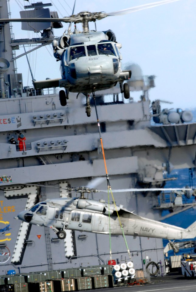 US Navy 070208-N-5345W-080 An MH-60S Seahawk assigned to Helicopter Combat Support Squadron Two Six (HSC-26) transfers ordnance from the flight deck of USS Theodore Roosevelt (CVN 71)