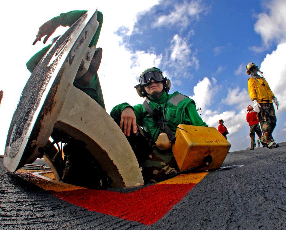 US Navy 070201-N-8923M-020 Aviation Boatswain's Mate 3rd Class Amanda Trouscher mans her jet blast deflector (JBD) operator post during training flight operations aboard Nimitz-class aircraft carrier USS Harry S. Truman (CVN 75