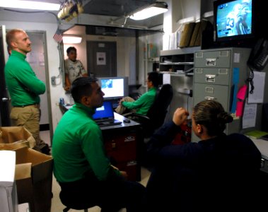 US Navy 070204-N-3659B-078 Sailors assigned to Airborne Early Warning Squadron One One Three (VAW-133) watch Super Bowl XLI in their work center aboard Nimitz-class aircraft carrier USS Ronald Reagan (CVN 76)