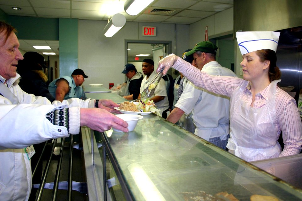 US Navy 070202-N-8110K-047 Information Systems Technician 1st Class Tanya Whitner and fellow Sailors assigned to guided missile cruiser USS Mahan (DDG 72) serve lunch to homeless veterans at the New England Shelter for Homeless