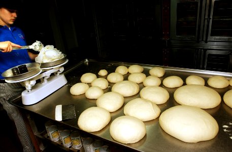 US Navy 070206-N-4009P-113 Culinary Specialist 3rd Class Lisa Greenlee, from Rockford, Ill., measures shortening for pie dough in the bakery aboard USS Ronald Reagan (CVN 76)
