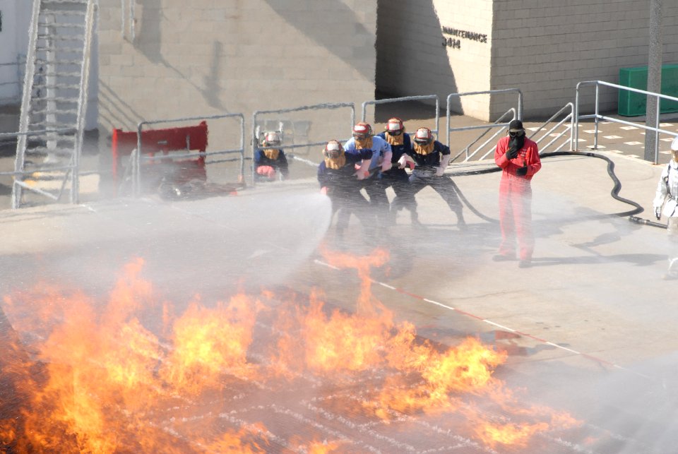 US Navy 070208-N-9195K-042 Sailors from USS John Paul Jones (DDG 53) begin attacking a simulated flight deck fire at the Aircraft Firefighting class held at Naval Base San Diego's firefighting school