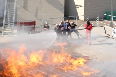 US Navy 070208-N-9195K-042 Sailors from USS John Paul Jones (DDG 53) begin attacking a simulated flight deck fire at the Aircraft Firefighting class held at Naval Base San Diego's firefighting school