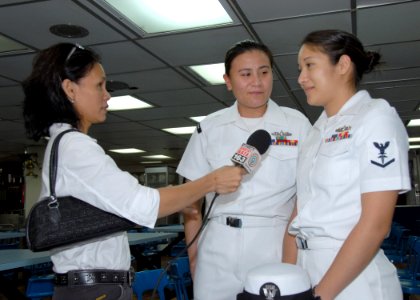 US Navy 070208-N-9860Y-087 Hospital Corpsman 3rd Class Cheryl Stahl and Yeoman 2nd Class Loribelle Valdez, a native of Olangapo, Philippines, are interviewed by a member of the ABS-CBN network to talk about shipboard life